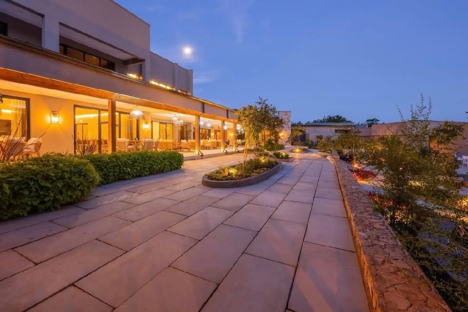 Stone-paved terrace walkway alongside the covered veranda at White River Manor at dusk